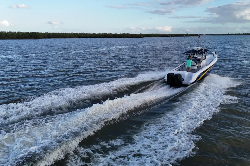 Slide: The Image of 2000 Donzi 35 boat cruising on open water, leaving a wake behind. - 25