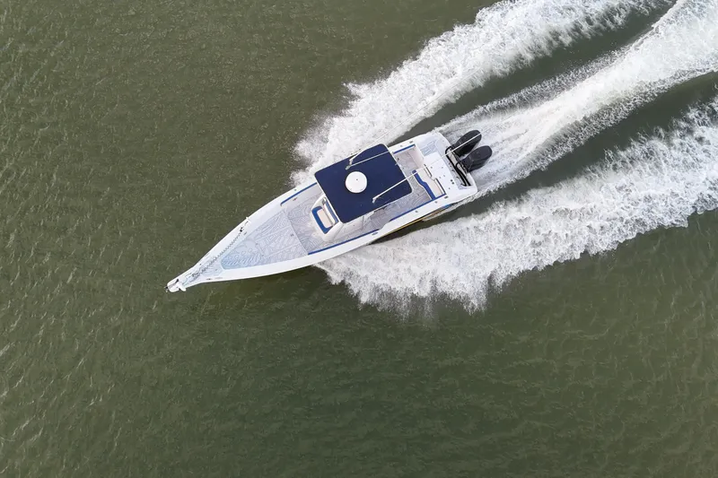 Slide: The Image of Aerial view of a 2000 Donzi 35 speedboat cruising on water. - 31