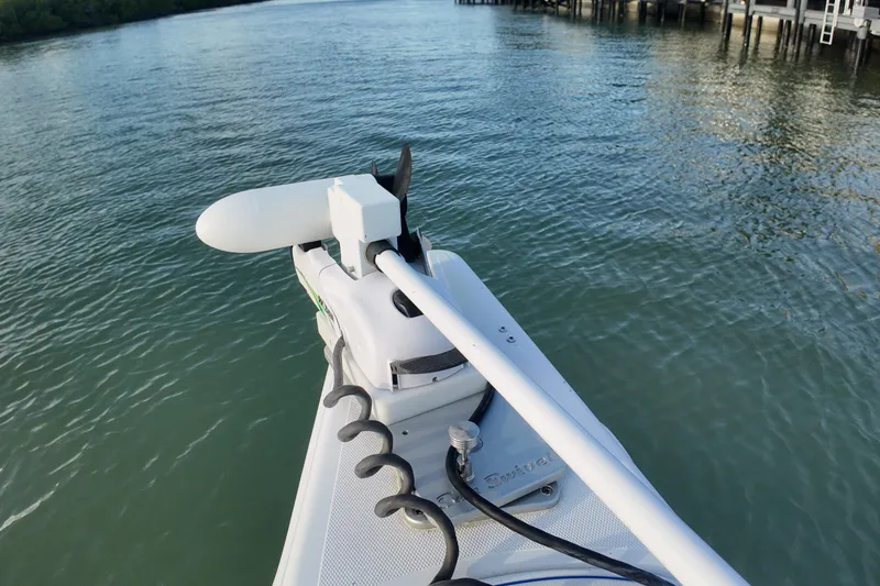 Slide: The Image of Bow of 2000 Donzi 35 boat with trolling motor on calm water. - 14