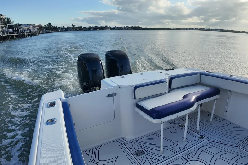 Slide: The Image of 2000 Donzi 35 boat with dual engines cruising on calm waters. - 16