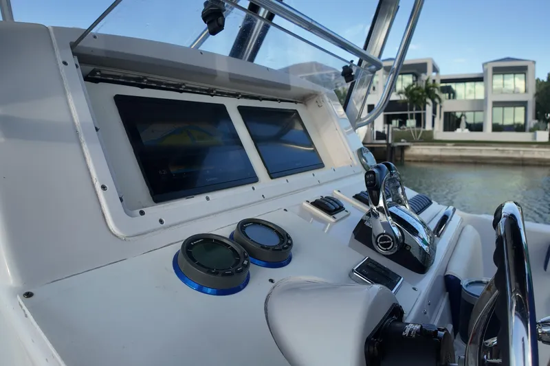 Slide: The Image of Control panel of a 2000 Donzi 35 boat with modern navigation equipment. - 19