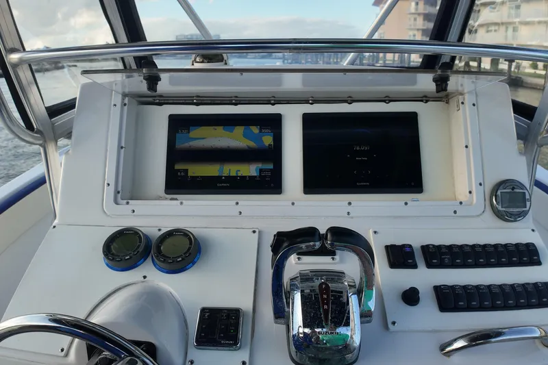 Slide: The Image of Control panel of a 2000 Donzi 35 boat with navigation screens and controls. - 20