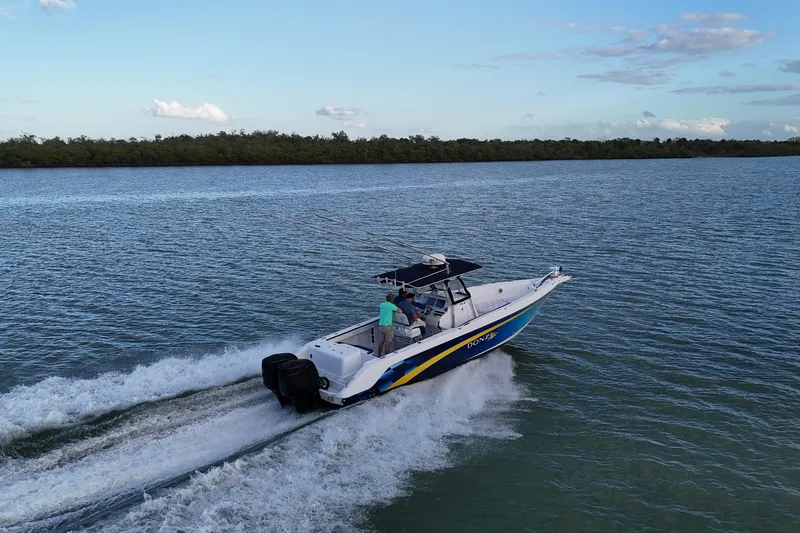 Slide: The Image of 2000 Donzi 35 boat cruising on open water under a clear sky. - 6
