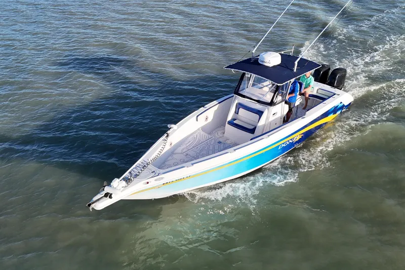 Slide: The Image of 2000 Donzi 35 boat cruising on open water, featuring sleek design and vibrant colors. - 7