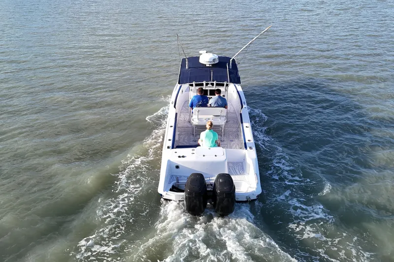 Slide: The Image of 2000 Donzi 35 boat cruising on open water with passengers onboard. - 8