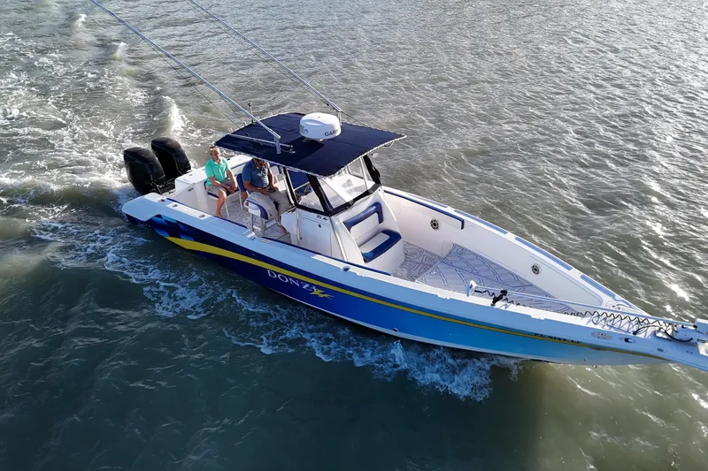 Slide: The Image of 2000 Donzi 35 boat cruising on water with two people onboard. - 9