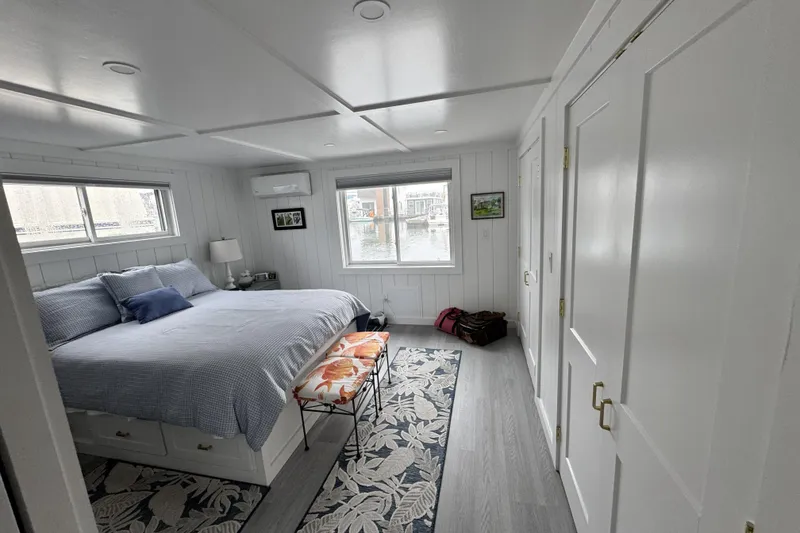 Slide: The Image of Modern bedroom interior on 2026 East Coast Houseboats Bayview, featuring cozy bed and stylish decor. - 13