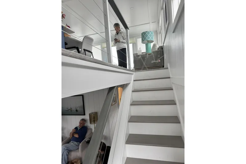 Slide: The Image of Interior of 2026 East Coast Houseboats Bayview, featuring modern staircase and cozy seating area. - 15