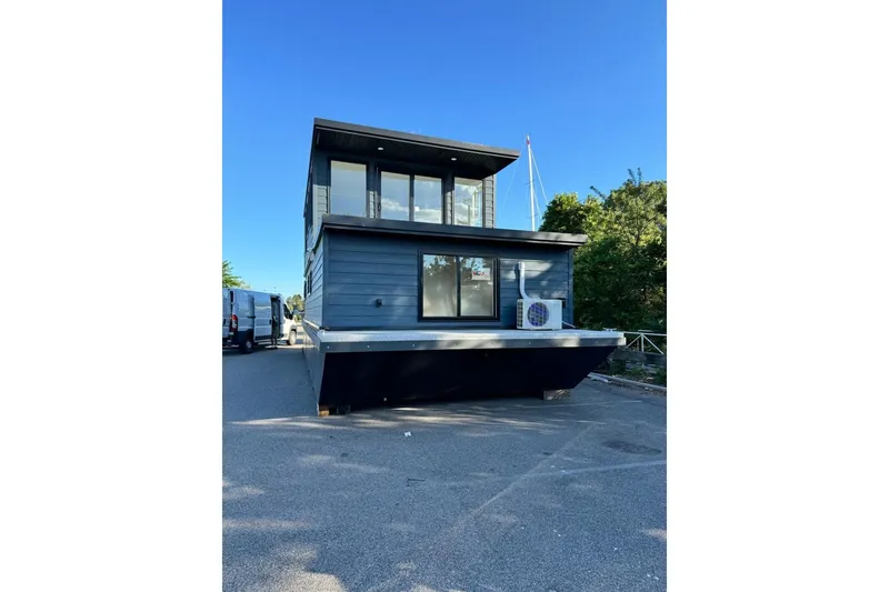 Slide: The Image of Modern 2026 East Coast Houseboat Bayview model on land, featuring sleek design and large windows. - 4