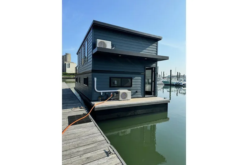 Slide: The Image of Modern 2026 East Coast Houseboat Bayview docked at marina, featuring sleek design and air conditioning units. - 9