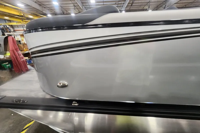 Slide: The Image of 2025 Avalon LSZ Quad Lounger boat in a warehouse setting. - 11