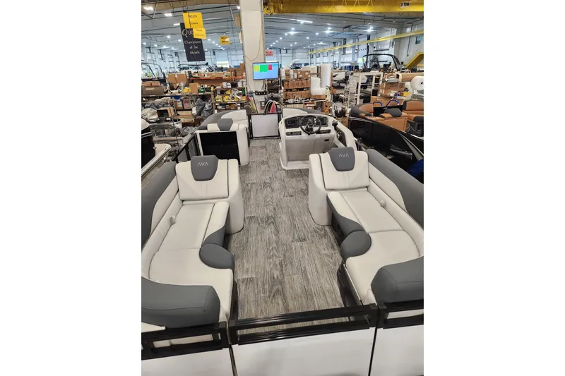 Slide: The Image of 2025 Avalon LSZ Quad Lounger interior with luxurious seating in a showroom setting. - 5