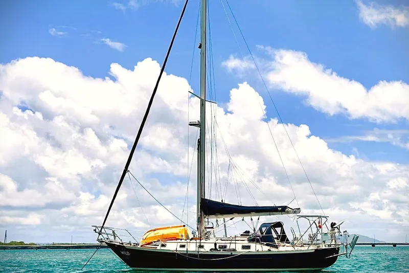 Slide: The Image of Sailboat Pacific Seacraft 37, 1998 model, anchored under a bright blue sky. - 6