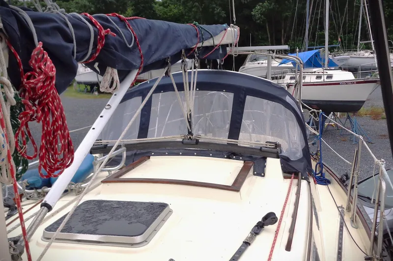 Slide: The Image of 1998 Pacific Seacraft 37 sailboat with covered deck, docked in a marina. - 4