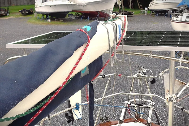 Slide: The Image of Sailboat Pacific Seacraft 37 (1998) with solar panels, docked in a boatyard. - 5