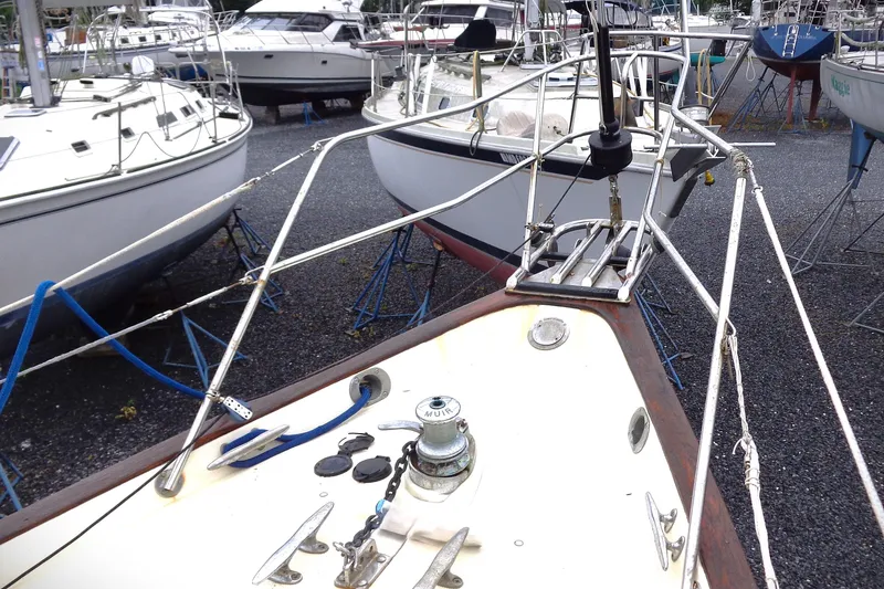 Slide: The Image of 1998 Pacific Seacraft 37 sailboat on land, surrounded by other boats. - 6