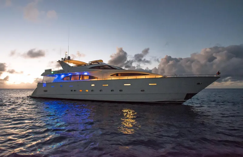 The Image of Luxurious 1999 Azimut 100 Jumbo yacht at sunset, featuring elegant lighting and serene ocean backdrop. - 0