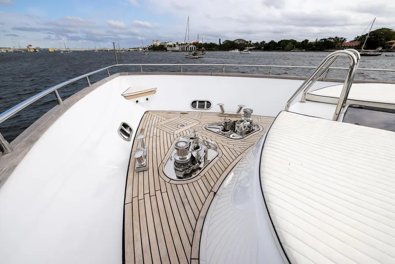 Slide: The Image of Luxury Azimut 100 Jumbo yacht deck with teak flooring, 1999 model, on a scenic waterfront. - 10