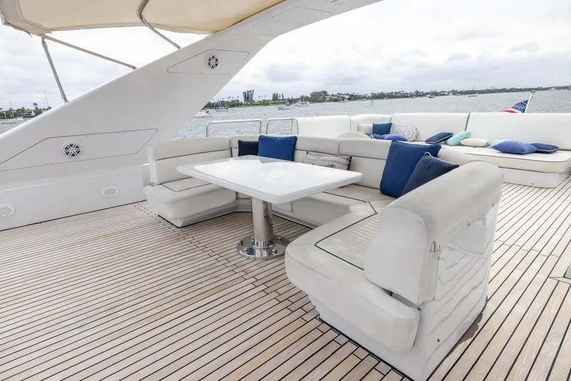 Slide: The Image of Luxurious deck seating on 1999 Azimut 100 Jumbo yacht, featuring elegant white cushions and a sleek table. - 24