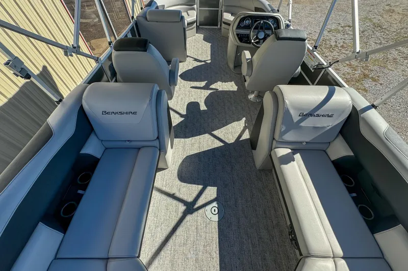 Slide: The Image of 2024 Berkshire 24RFX LE pontoon boat interior with gray seating and steering console. - 10