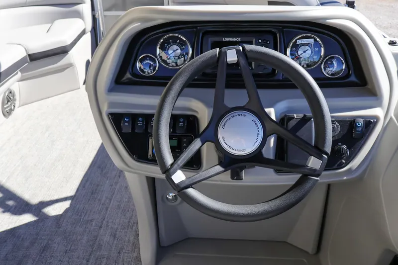 Slide: The Image of 2024 Berkshire 24RFX LE boat dashboard with steering wheel and control panel. - 13