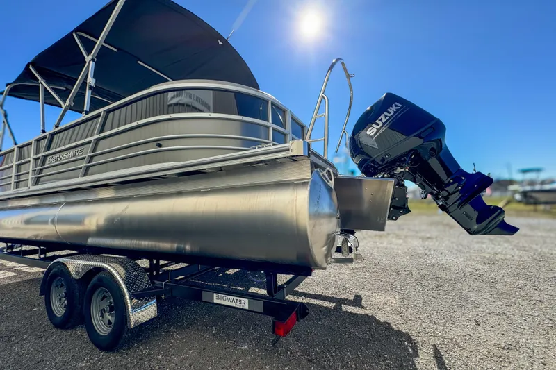 Slide: The Image of 2024 Berkshire 24RFX LE pontoon boat with Suzuki outboard motor on trailer. - 4