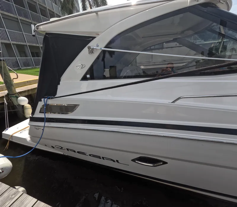 Slide: The Image of 2015 Regal 35 Sport Coupe docked, side view with sleek design and modern features. - 11