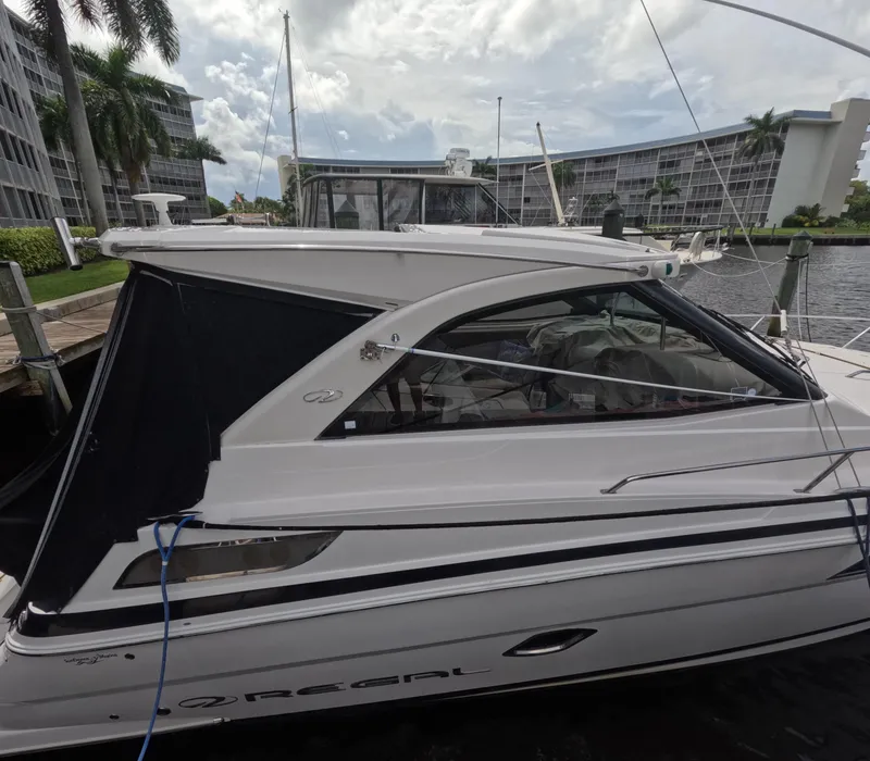 Slide: The Image of 2015 Regal 35 Sport Coupe docked near waterfront buildings. - 12