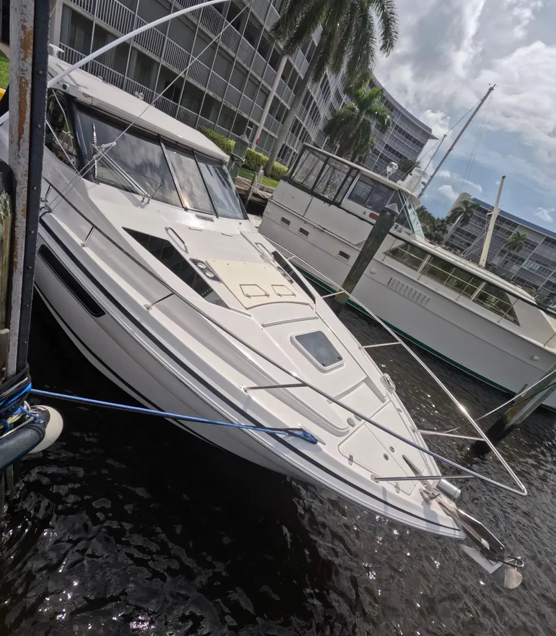 Slide: The Image of 2015 Regal 35 Sport Coupe docked near waterfront buildings. - 16