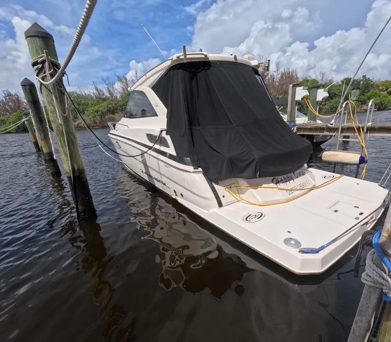 Slide: The Image of 2015 Regal 35 Sport Coupe docked in a marina, covered with a black tarp. - 2