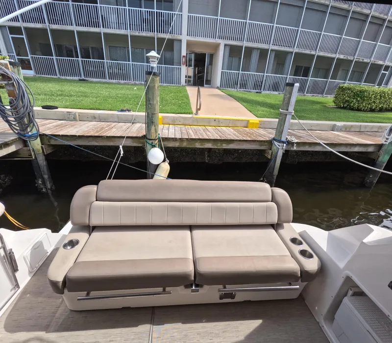 Slide: The Image of 2015 Regal 35 Sport Coupe boat with beige seating at a dock. - 39