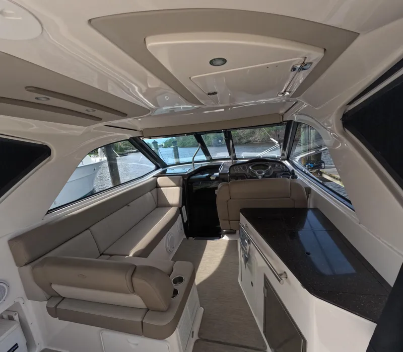 Slide: The Image of 2015 Regal 35 Sport Coupe interior with seating and kitchenette. - 40