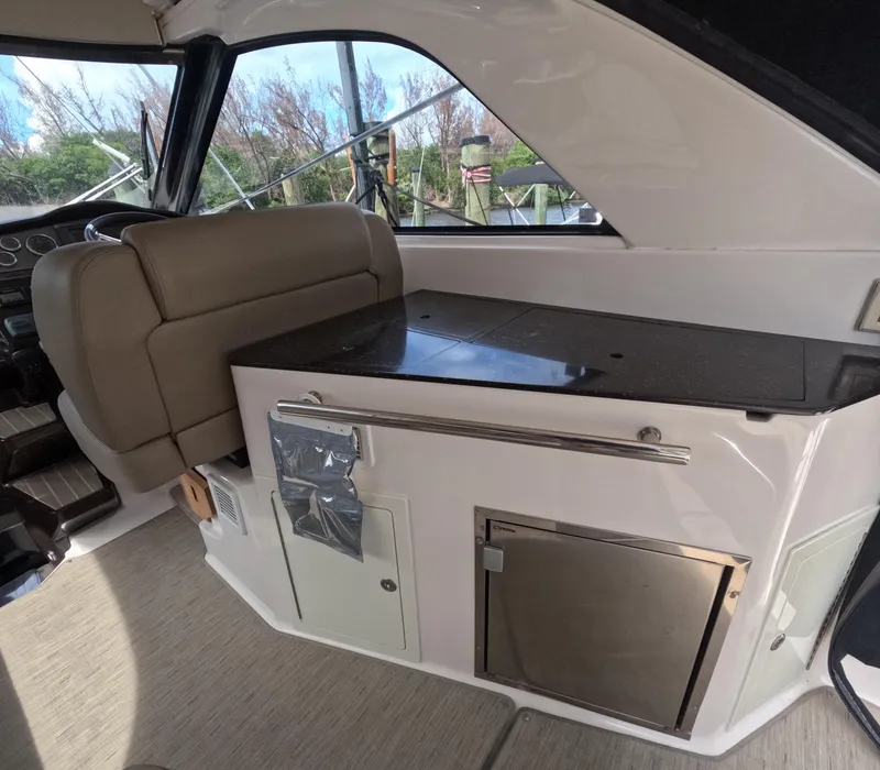 Slide: The Image of Interior of 2015 Regal 35 Sport Coupe with seating and kitchenette area. - 45