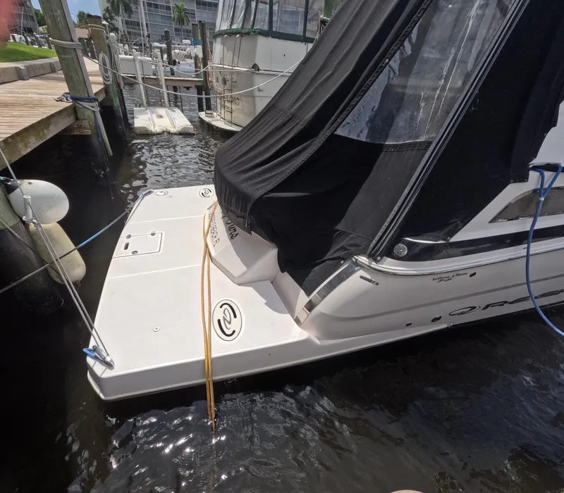 Slide: The Image of 2015 Regal 35 Sport Coupe docked at marina, rear view with black cover. - 9