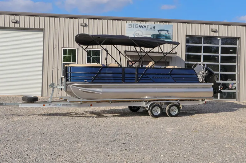 The Image of 2024 Berkshire 24UL CTS pontoon boat on trailer outside Big Water Marine. - 1