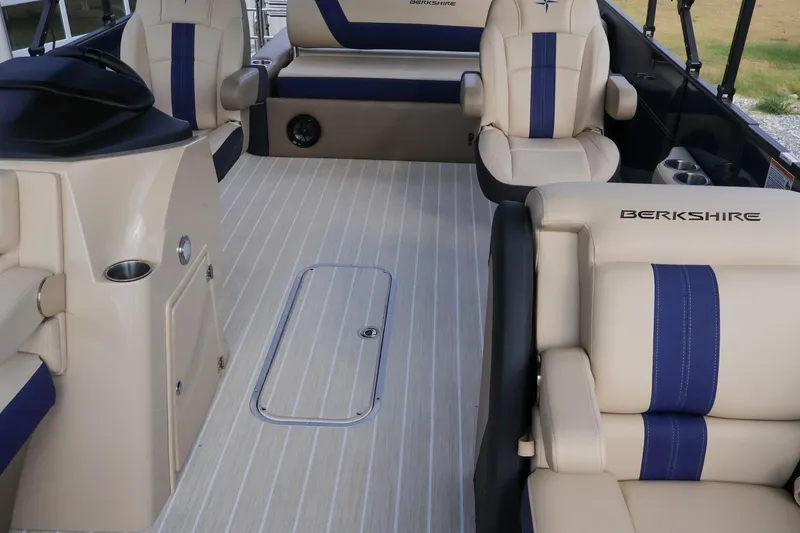Slide: The Image of 2024 Berkshire 24UL CTS boat interior with beige and blue seating, spacious layout. - 14