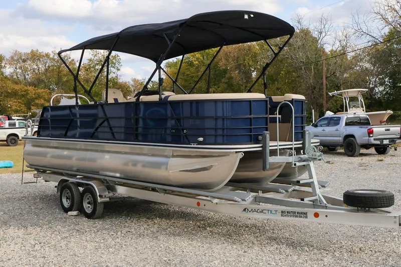 Slide: The Image of 2024 Berkshire 24UL CTS pontoon boat on trailer, parked outdoors. - 3