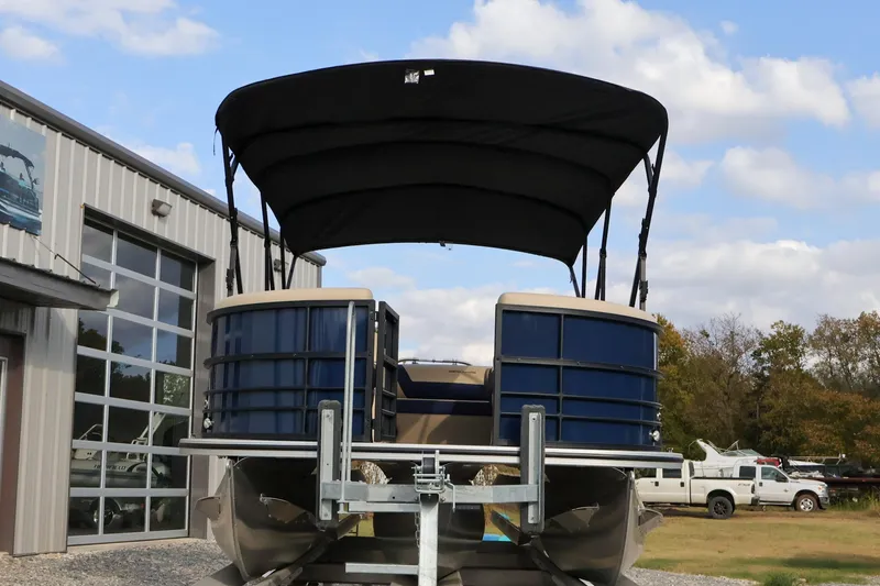 Slide: The Image of 2024 Berkshire 24UL CTS pontoon boat with canopy, parked outside a building. - 5