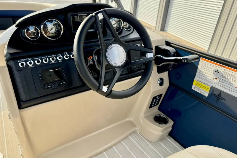Slide: The Image of 2024 Berkshire 24UL CTS boat dashboard with steering wheel and control panel. - 8