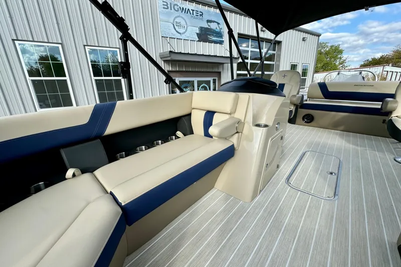 Slide: The Image of 2024 Berkshire 24UL CTS pontoon boat interior with beige and blue seating. - 9