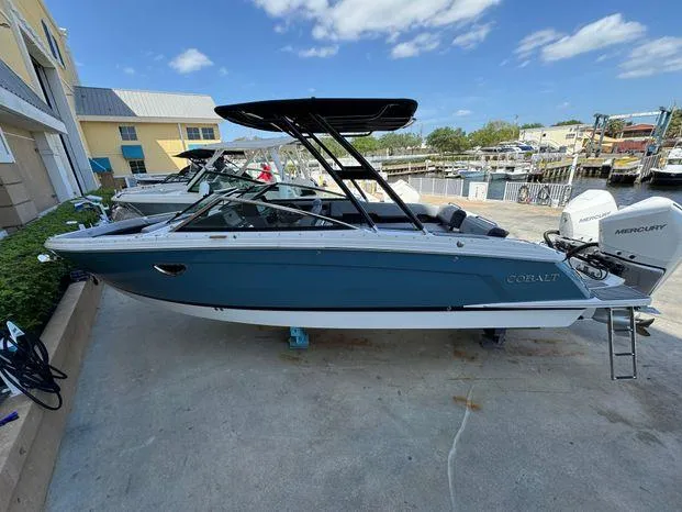 Slide: The Image of 2023 Cobalt R8 Outboard boat with Mercury engines, docked outdoors under a clear sky. - 3