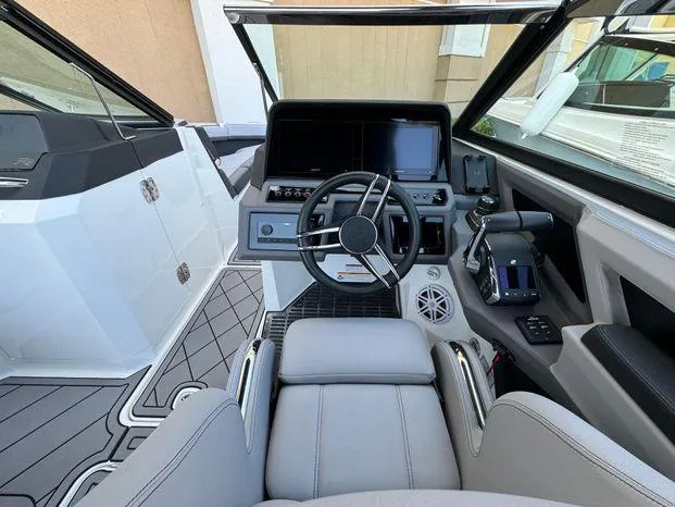 Slide: The Image of 2023 Cobalt R8 Outboard boat cockpit with modern steering and controls. - 30