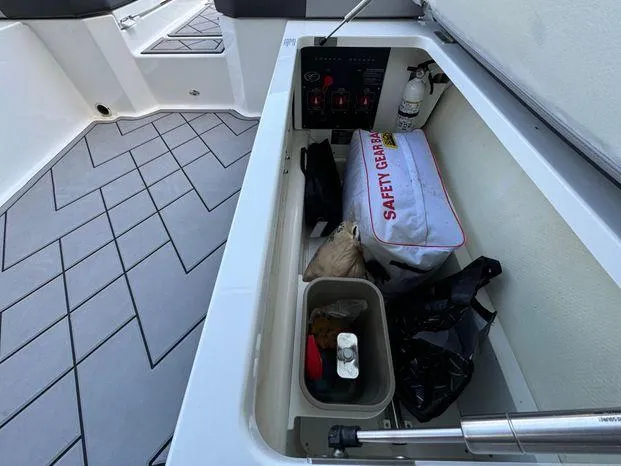 Slide: The Image of Storage compartment in 2023 Cobalt R8 Outboard boat with safety gear and equipment. - 43
