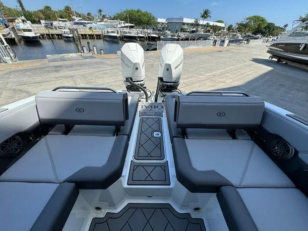 Slide: The Image of 2023 Cobalt R8 Outboard boat interior with dual engines at a marina. - 45