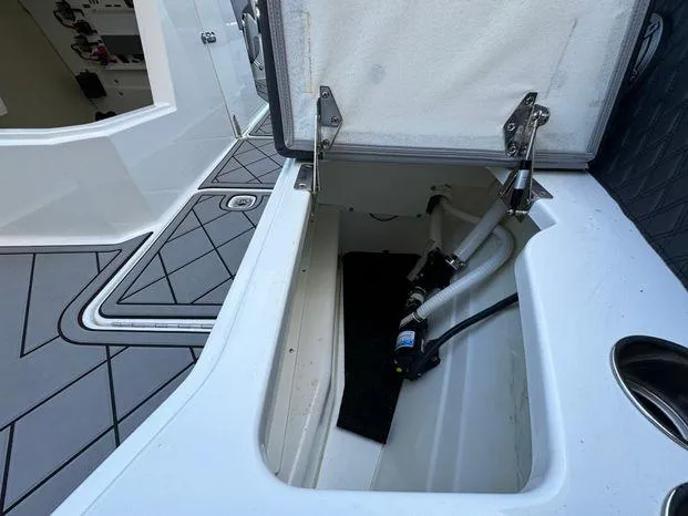 Slide: The Image of Open storage compartment on 2023 Cobalt R8 Outboard boat deck. - 46