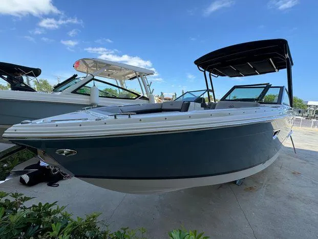 Slide: The Image of 2023 Cobalt R8 Outboard boat with sleek design, docked under clear blue sky. - 5