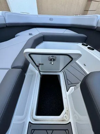 Slide: The Image of 2023 Cobalt R8 Outboard boat interior with open storage compartment. - 51