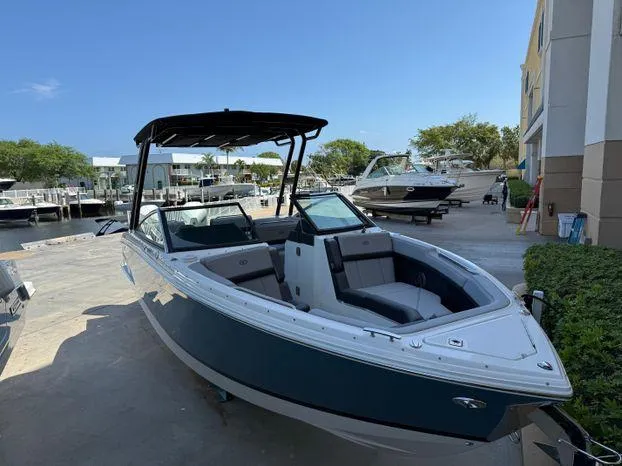 Slide: The Image of 2023 Cobalt R8 Outboard boat docked at marina, sleek design, blue hull. - 7