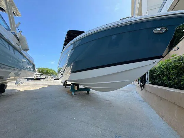 Slide: The Image of 2023 Cobalt R8 Outboard boat on display, sleek design, blue hull, outdoor setting. - 8