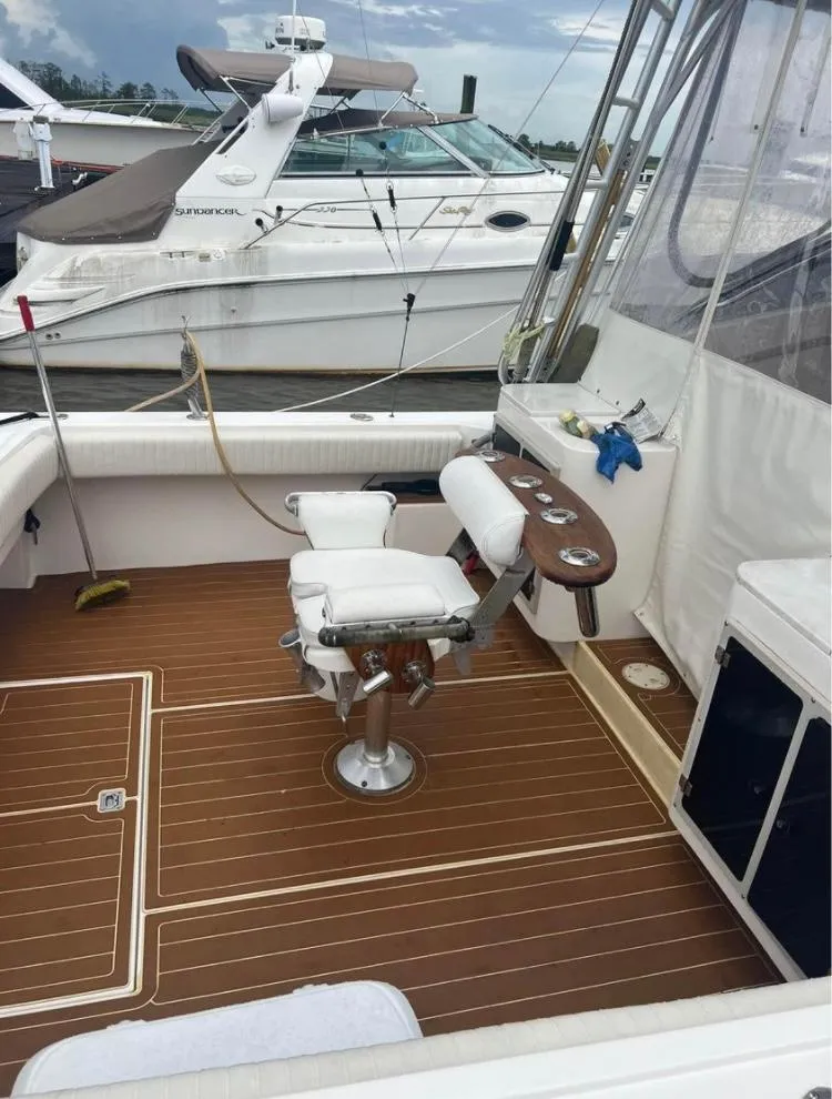 Slide: The Image of 1998 Albemarle 320 Express Fisherman boat with teak deck and fishing chair. - 15